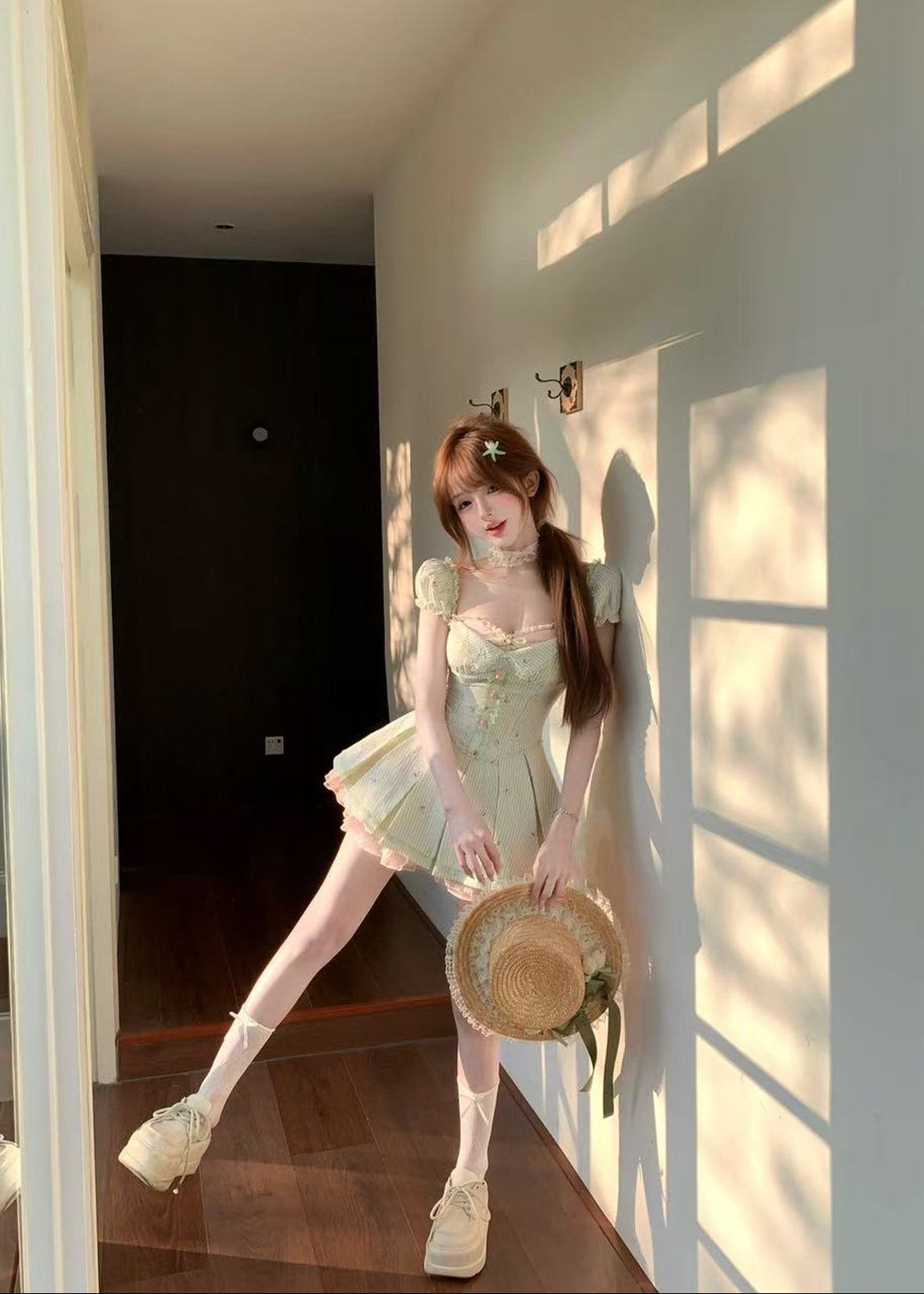 Woman in a light green dress holding a woven basket in a sunlit room.