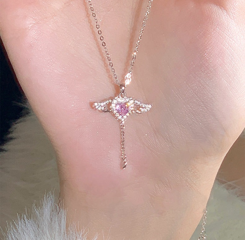 Necklace with a pink gemstone pendant on a person's neck