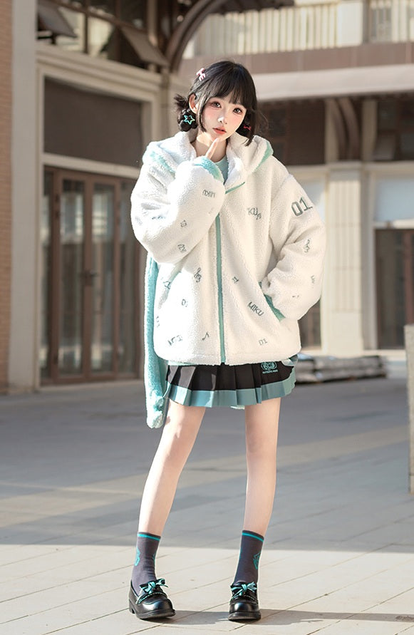 Woman wearing a white jacket with green accents and a skirt, standing outdoors.