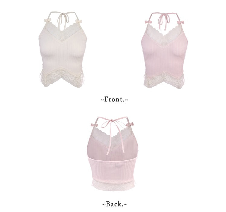 A woman wearing a gray and pink floral three-piece set with a top, bloomers, and a camisole.