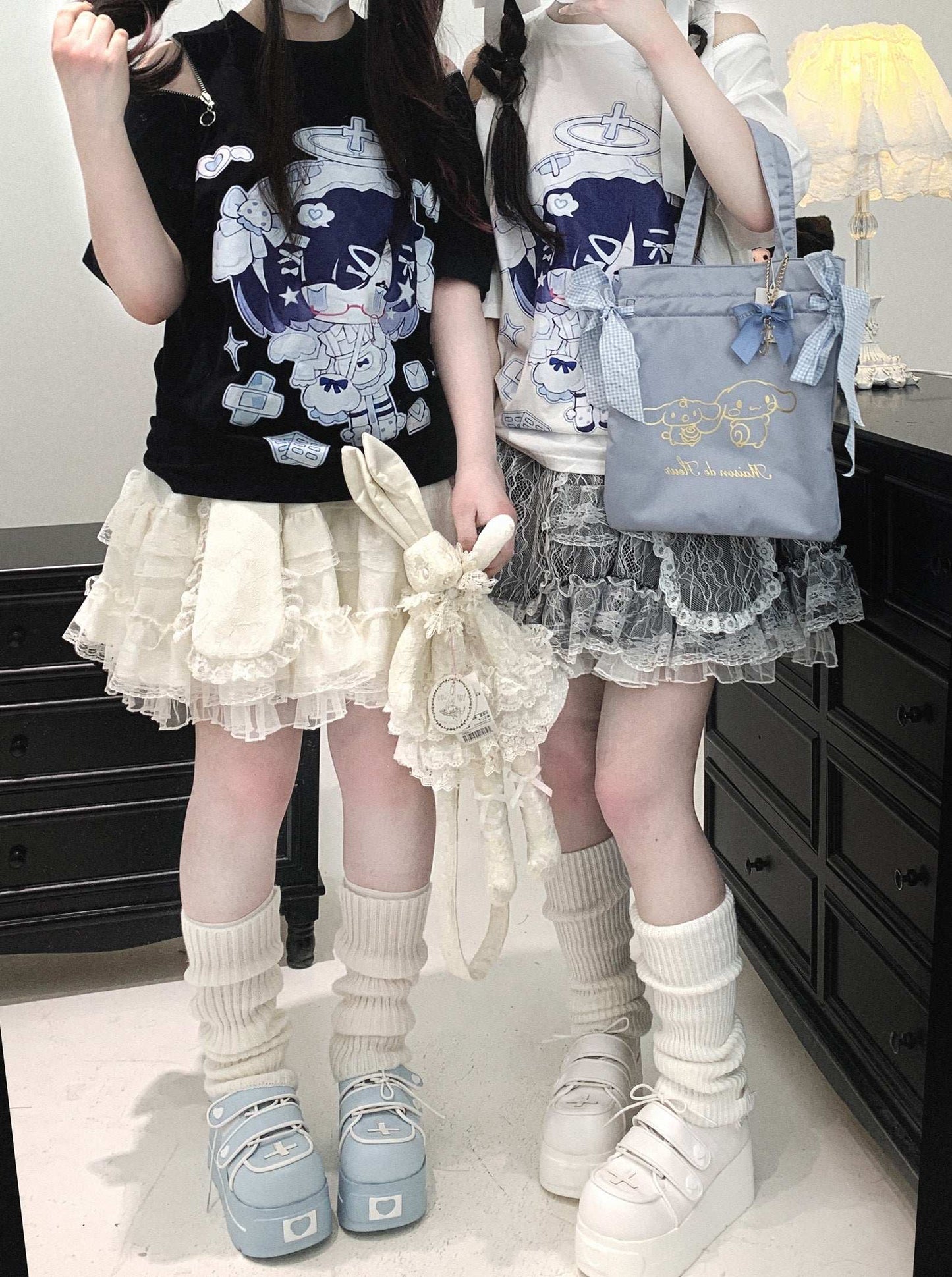 Two people wearing cute outfits with skirts and accessories in a room.