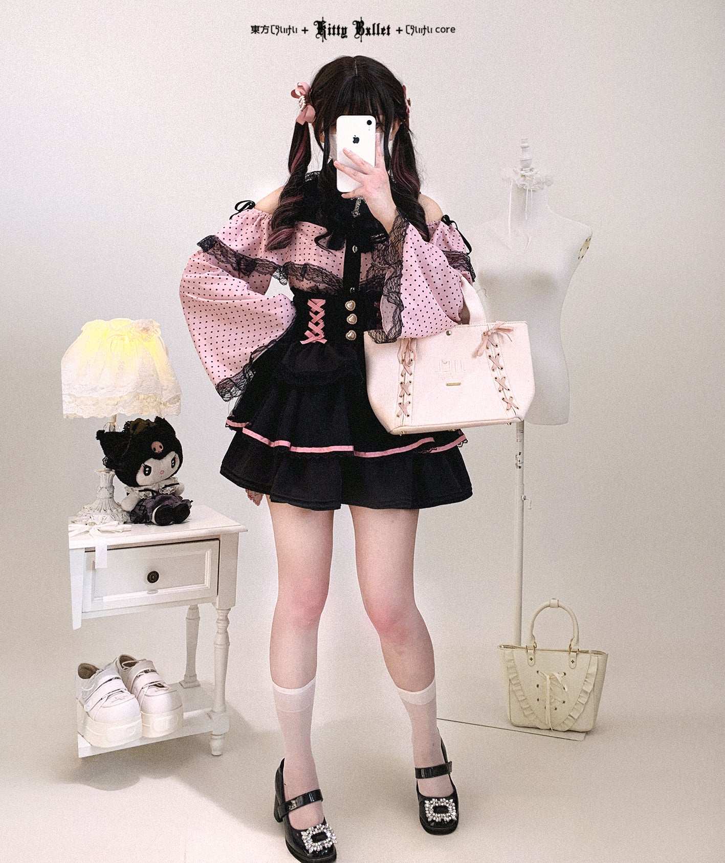 Person wearing a black and pink outfit with a white background