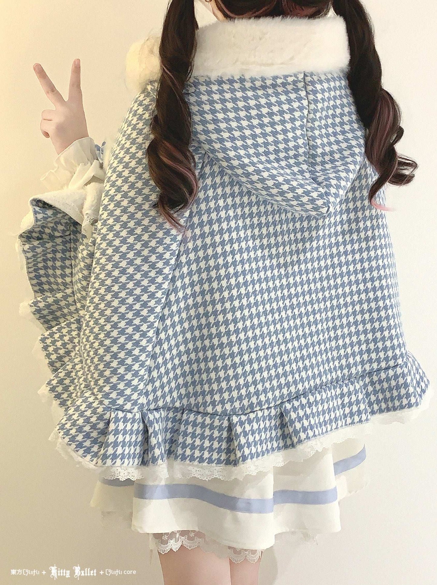 Person wearing a blue and white checkered dress with ruffled details.