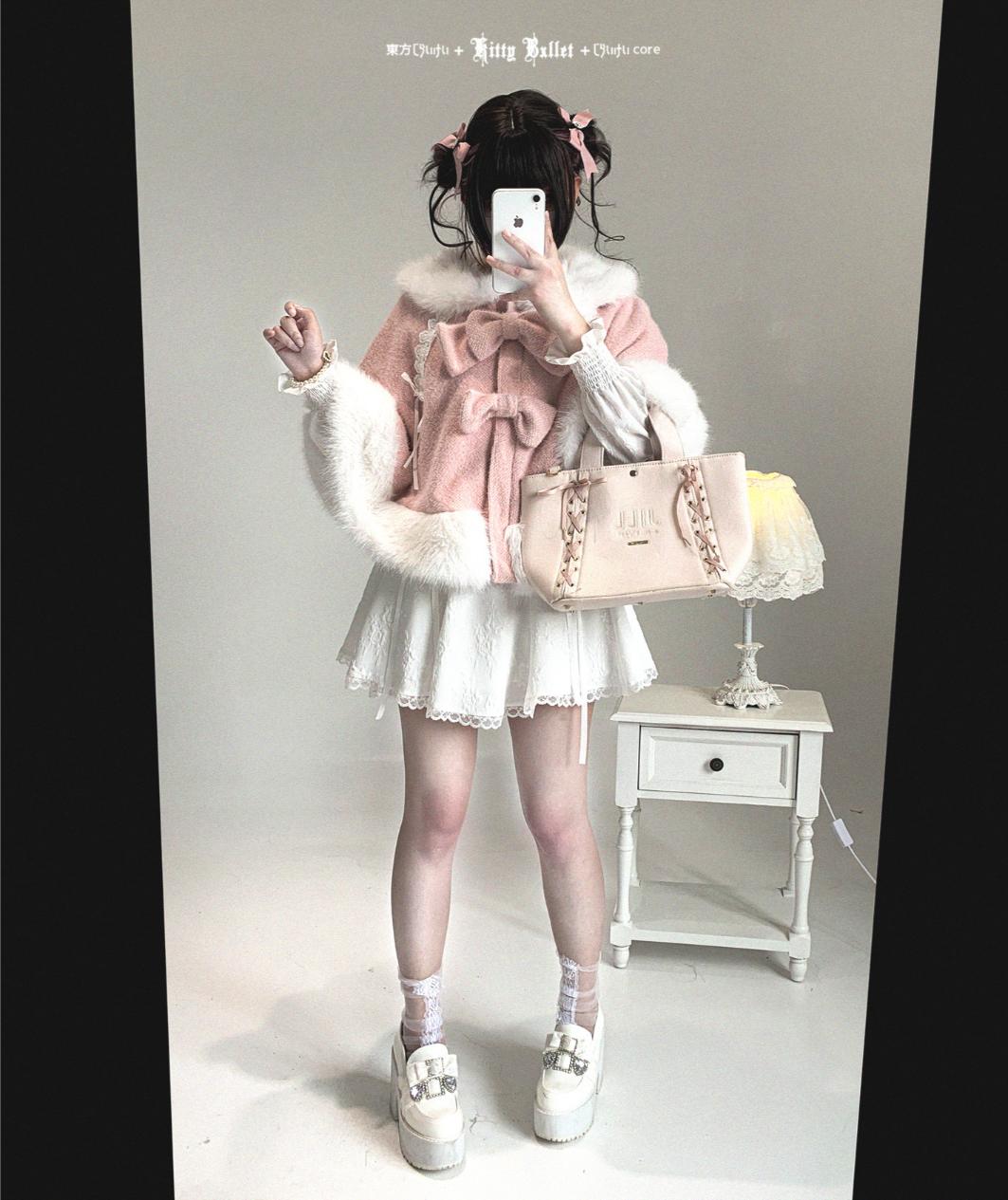Person wearing a pink outfit with white fur trim, holding a beige handbag.