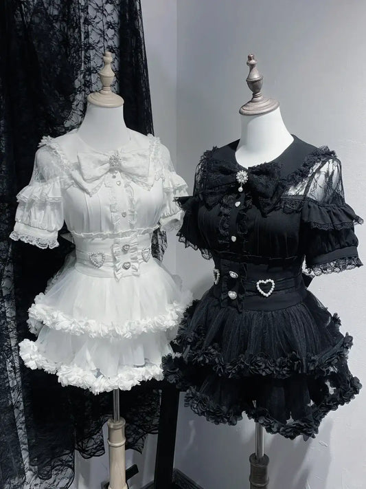 Two mannequins dressed in white and black Lolita-style dresses against a plain background.