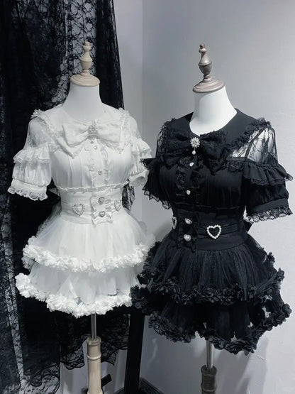 Two mannequins dressed in white and black Lolita-style dresses against a plain background.