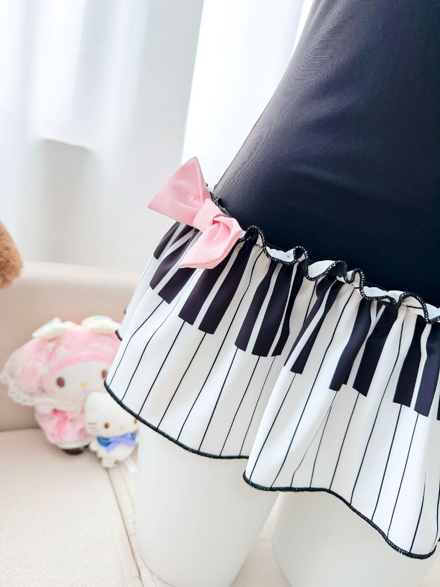 Piano key patterned skirt with a pink bow on a white background