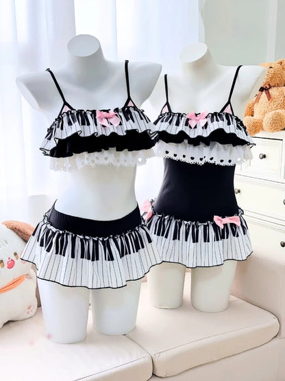 Black and white ruffled lingerie set on mannequins with a teddy bear in the background.
