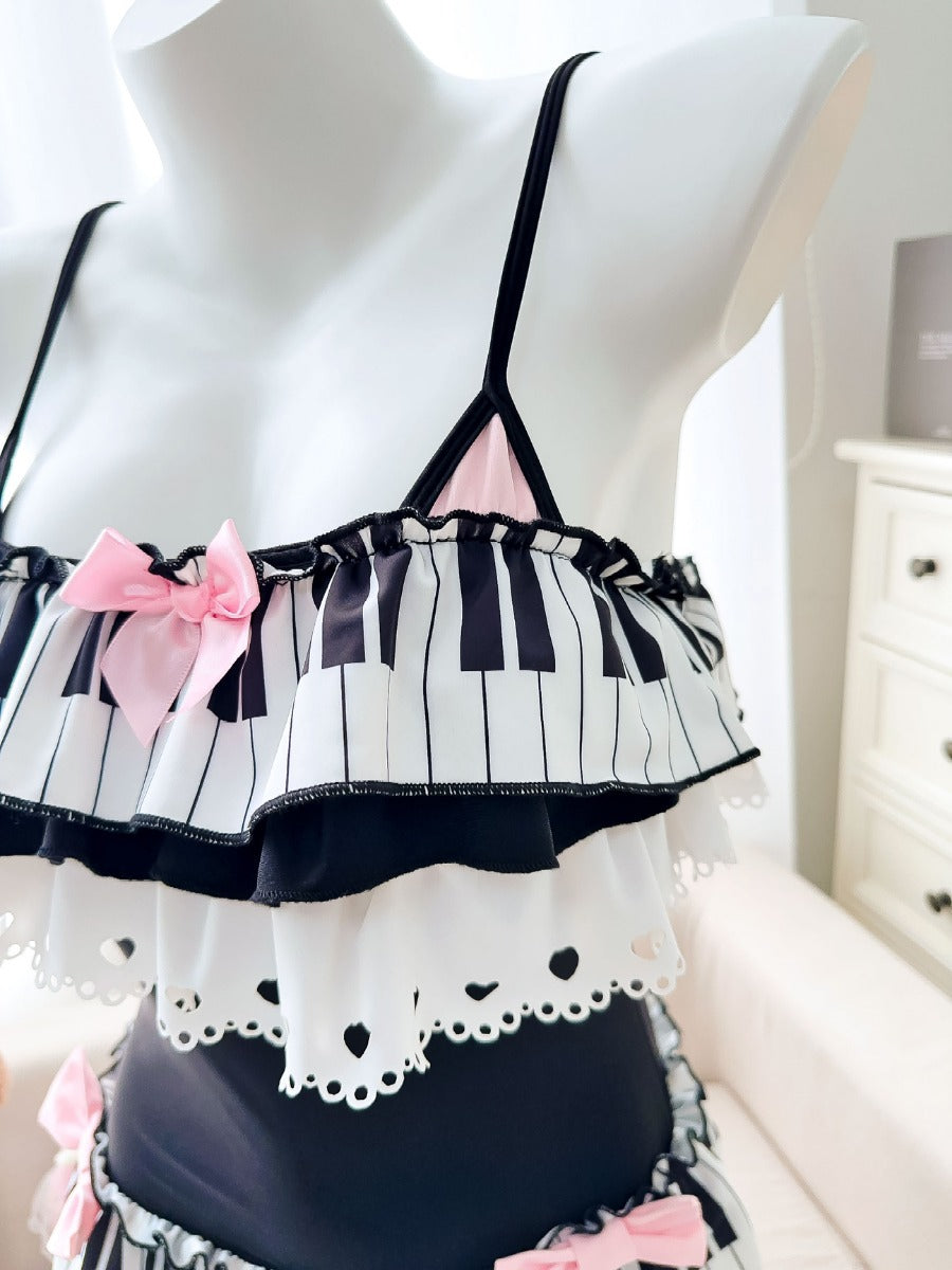 Mannequin wearing a black and white striped top with pink bows on a white background