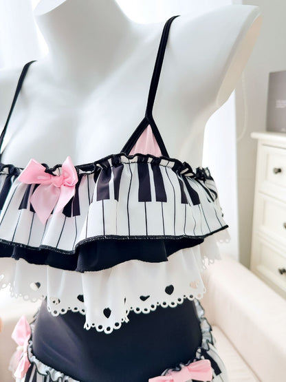 Mannequin wearing a black and white striped top with pink bows on a white background