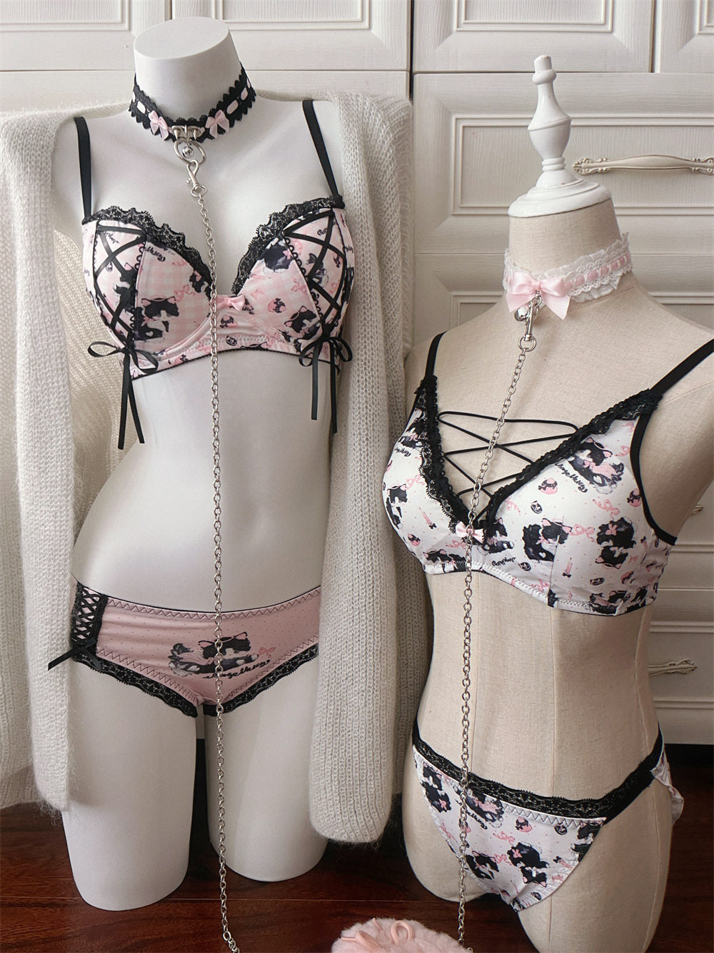 Two mannequins wearing floral lingerie set against a neutral background
