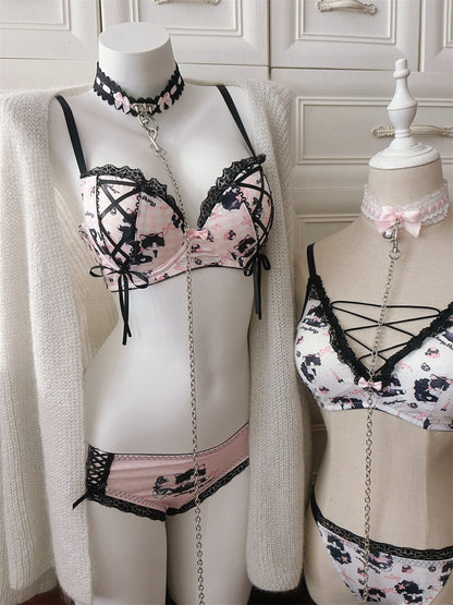 Two mannequins wearing black and white lingerie set against a neutral background.