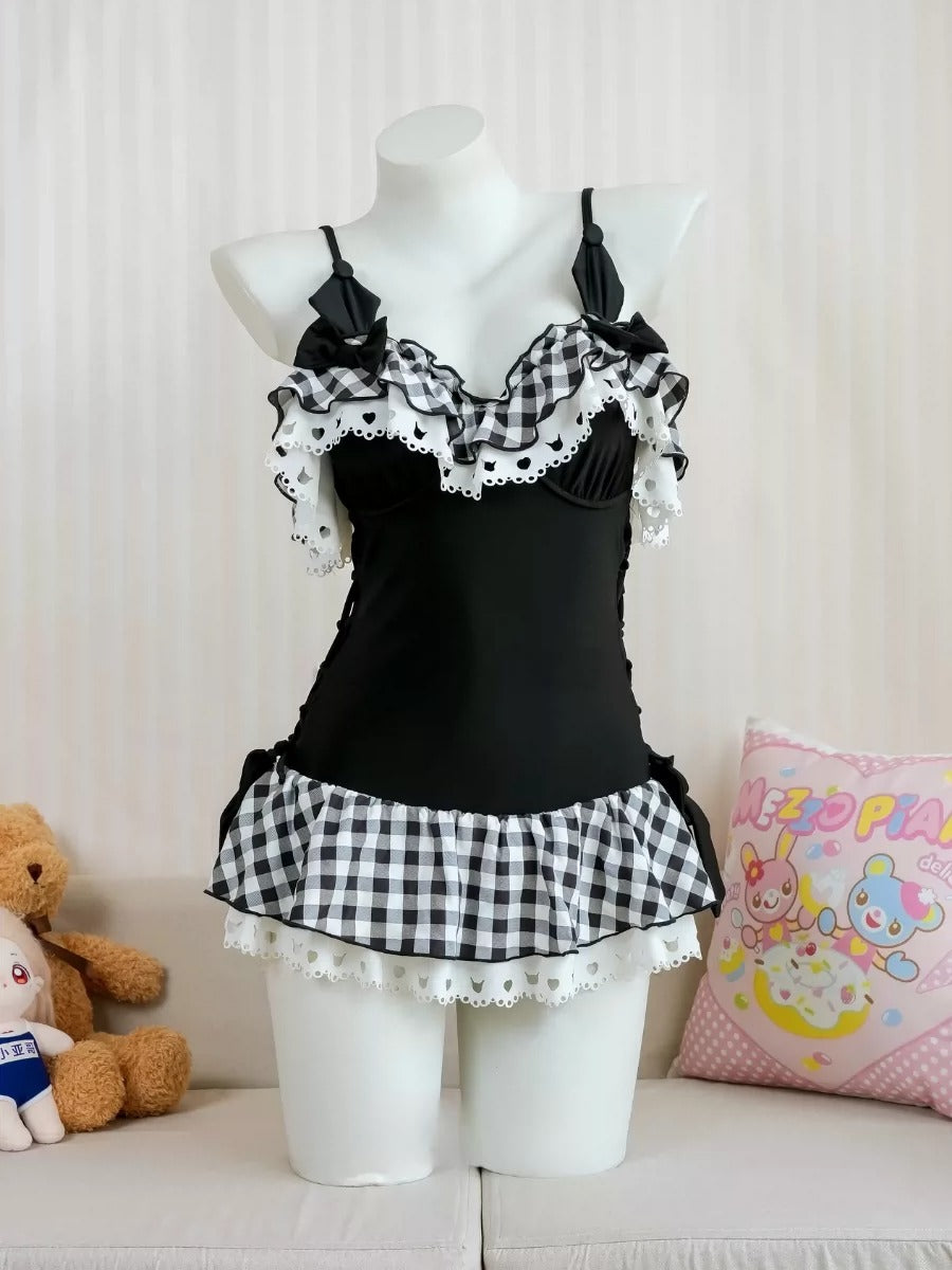 Black tank top with checkered ruffle on a mannequin against a light background