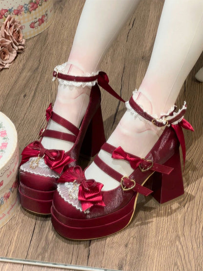 Red platform shoes with floral details on a wooden floor