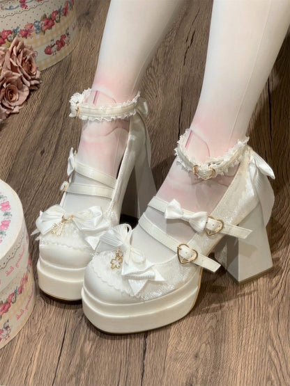 White platform heels with decorative bows on a wooden floor.