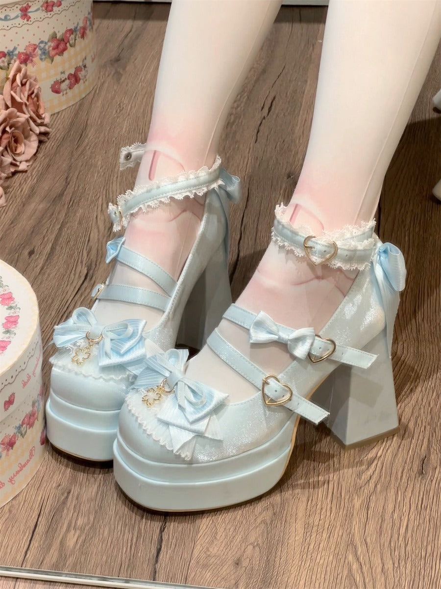 Light blue platform heels with floral details on a wooden floor.