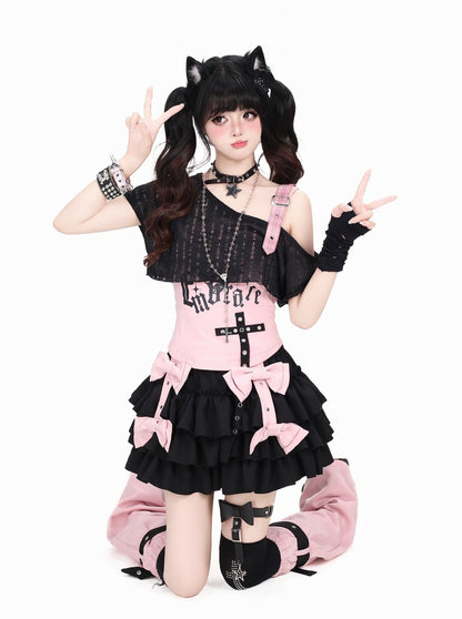 A model kneeling on a white background wearing a gothic Lolita-style outfit with pink and black ruffles, cat ears, and accessories.