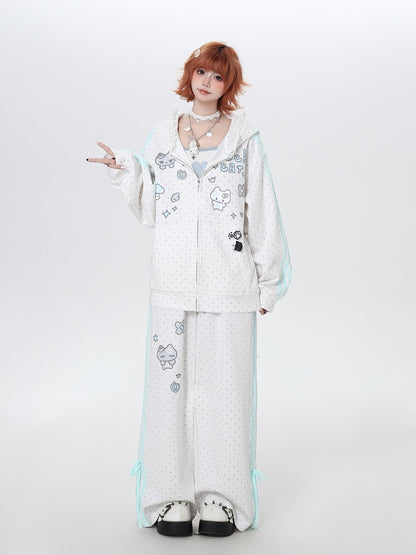 Person wearing a white outfit with cartoon designs on a plain background