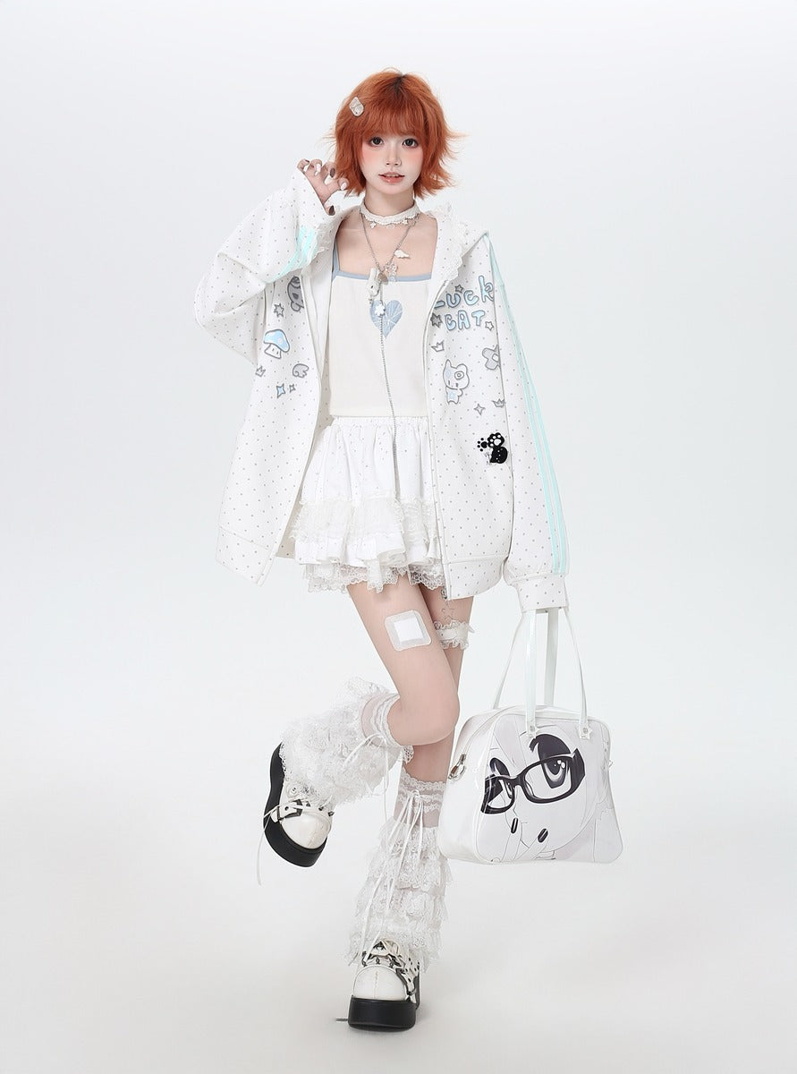 Person wearing a white outfit with cartoon character designs, holding a matching bag on a white background