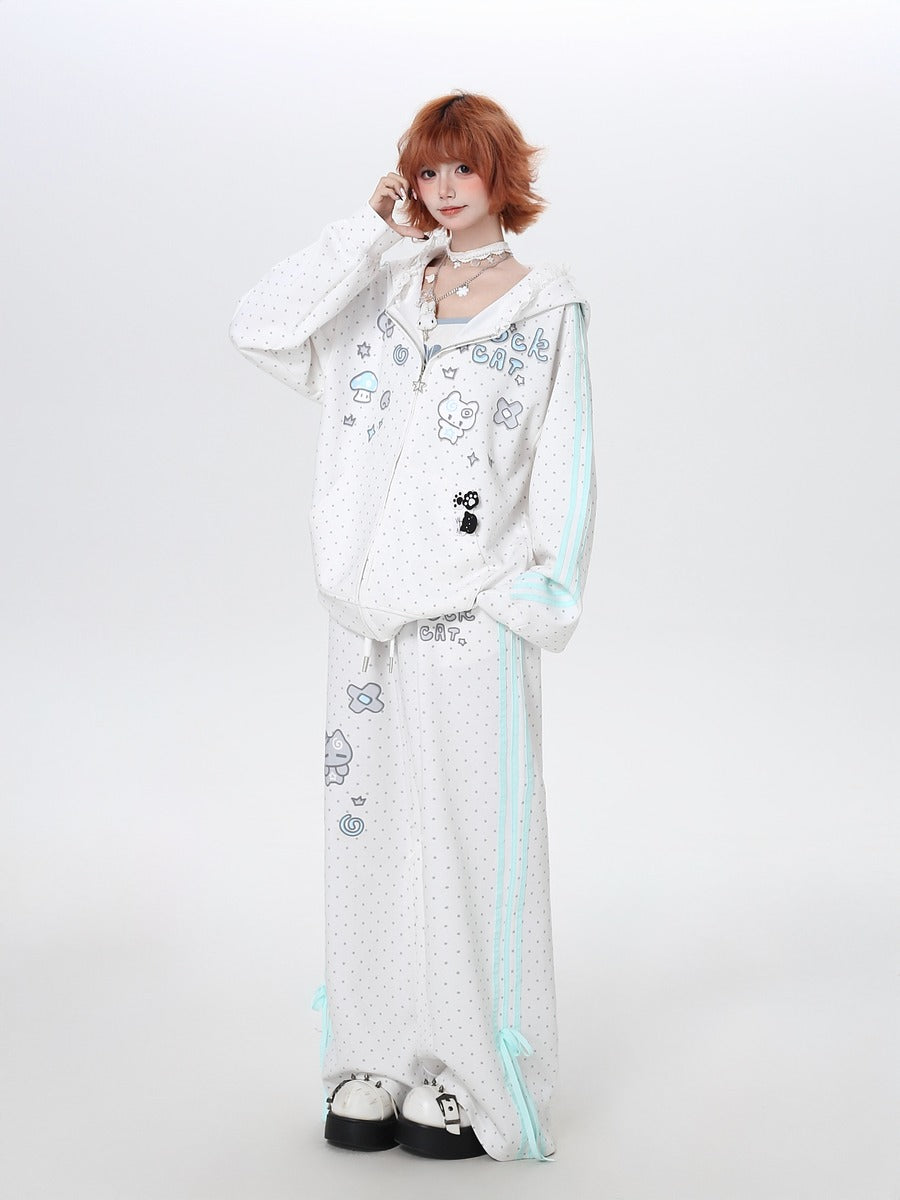 Person wearing a white outfit with cartoon character designs on a plain background