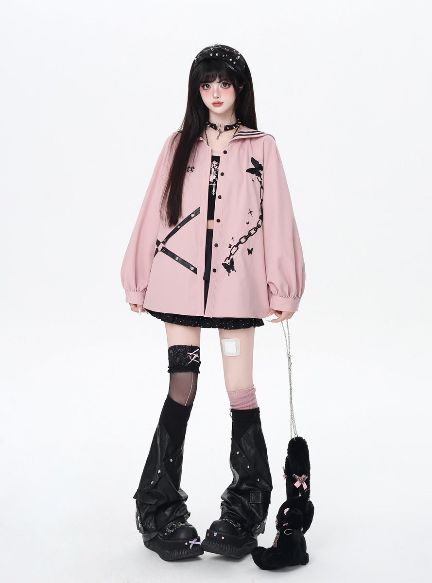 Person wearing a pink jacket with black designs on a white background