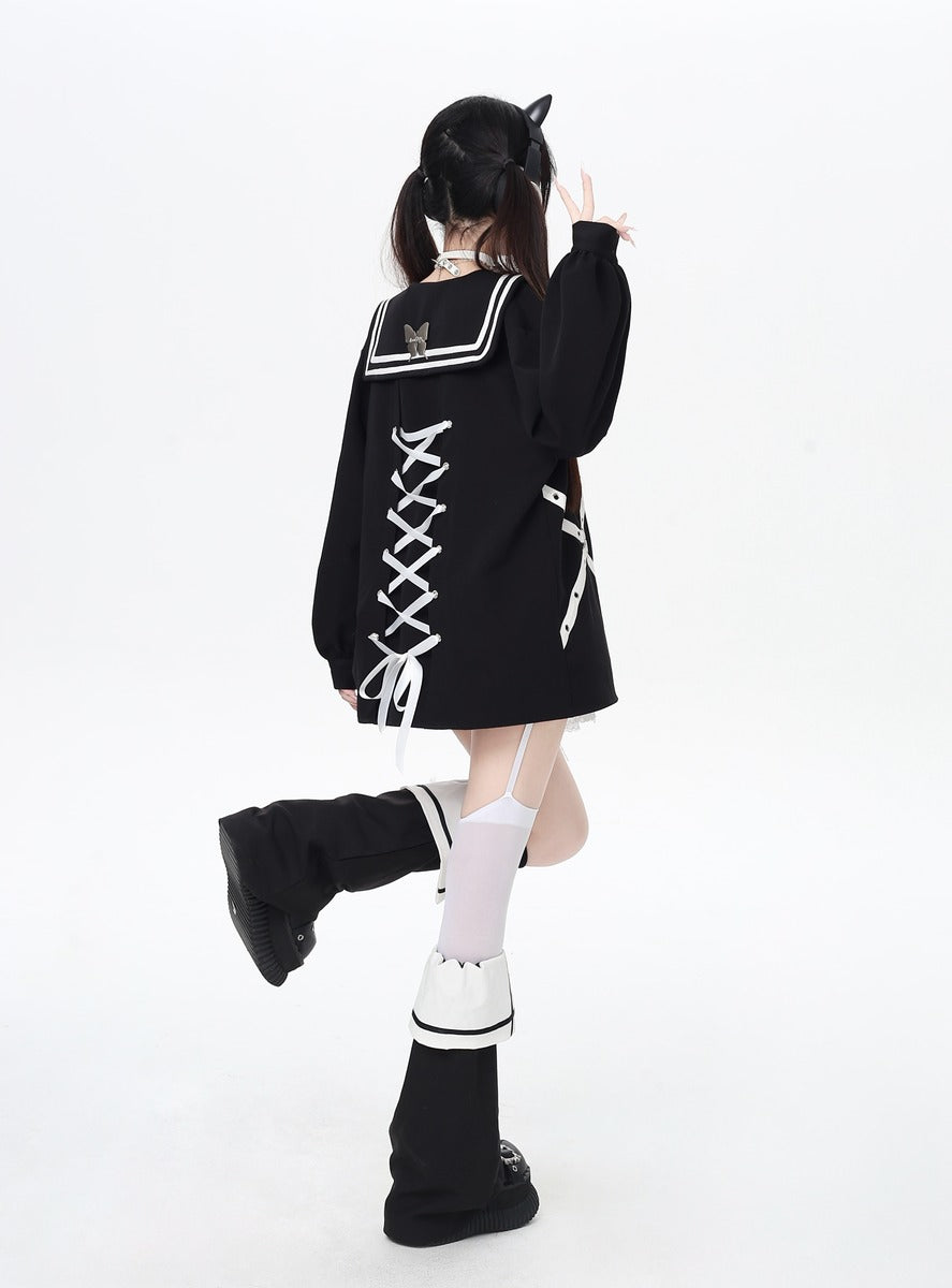 Person wearing a black outfit with white accents on a white background