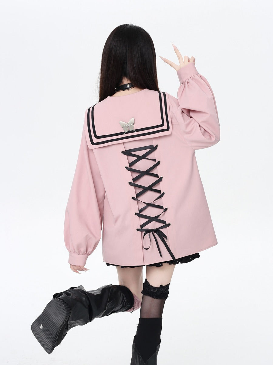 Person wearing a pink jacket with a unique back design on a white background