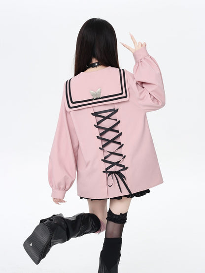 Person wearing a pink jacket with a unique back design on a white background