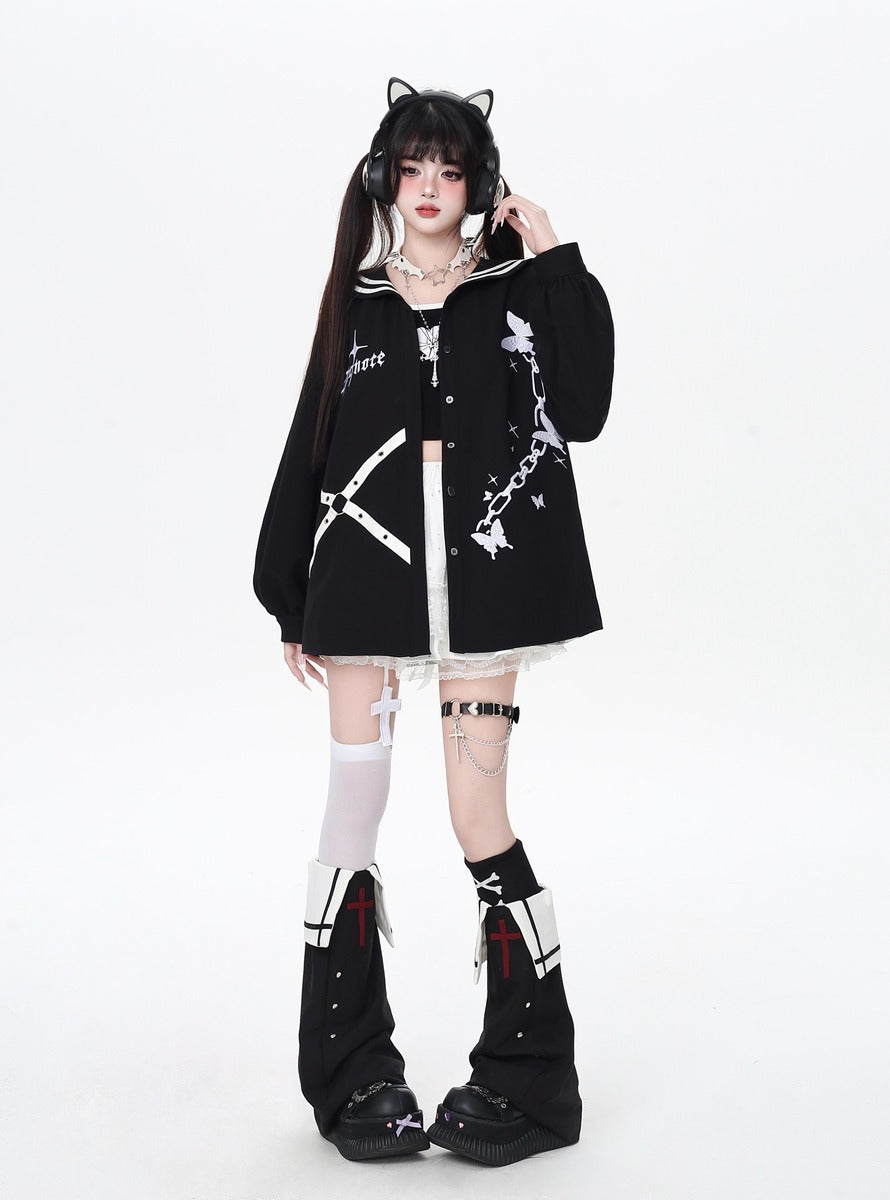 Person wearing a black outfit with white accents on a white background