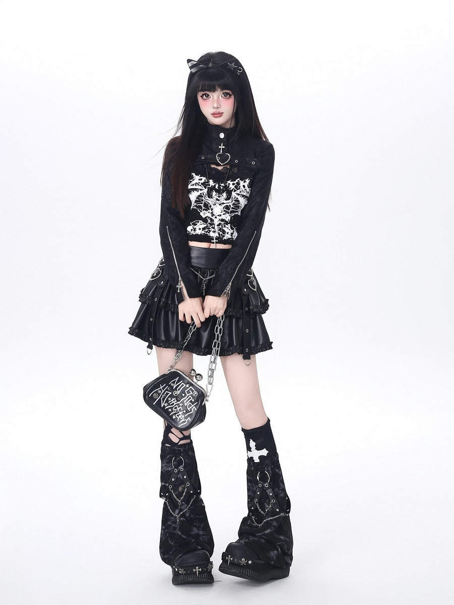 Person wearing a black gothic outfit with a skirt, top, and boots on a white background