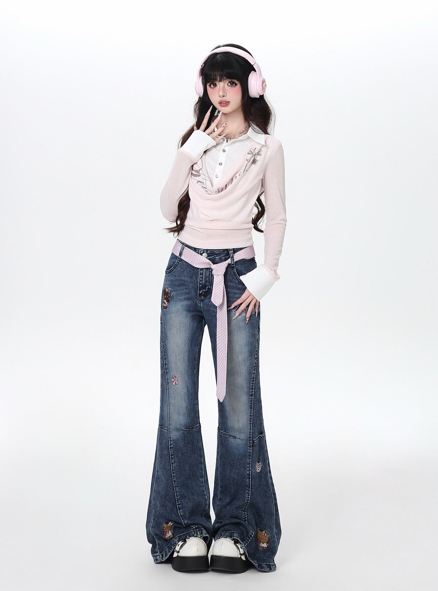 Person wearing a pink sweater and blue jeans with a white background