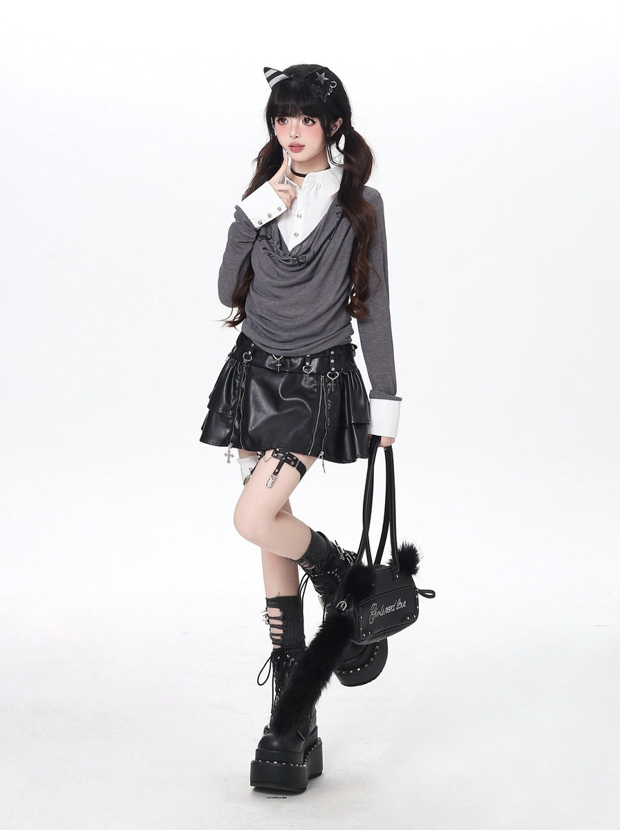 Person wearing a gothic-inspired outfit with a black leather skirt, gray sweater, and black boots on a white background.