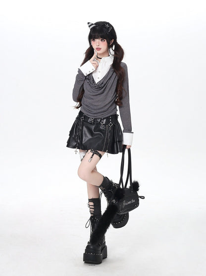 Person wearing a gothic-inspired outfit with a black leather skirt, gray sweater, and black boots on a white background.