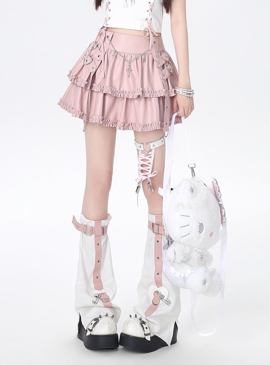 Person wearing a pink skirt, white stockings, and high-heeled shoes with decorative straps on a white background