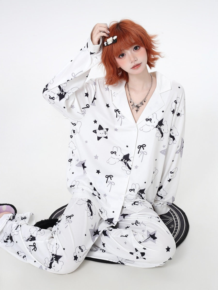 Person wearing a white cozy pajamas with black patterns on a white background