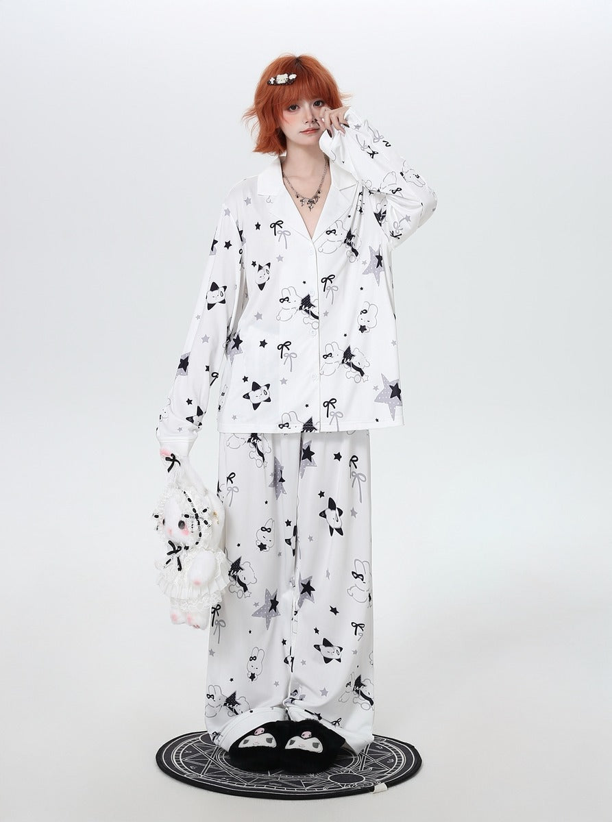 Person wearing a white cozy pajamas with black floral patterns on a white background