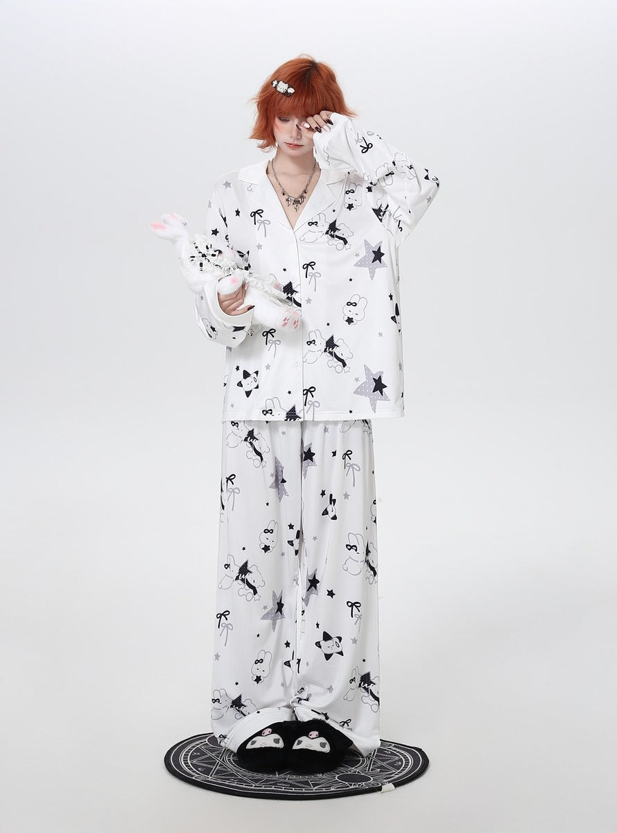 Person wearing a white pajama set with black patterns on a white background