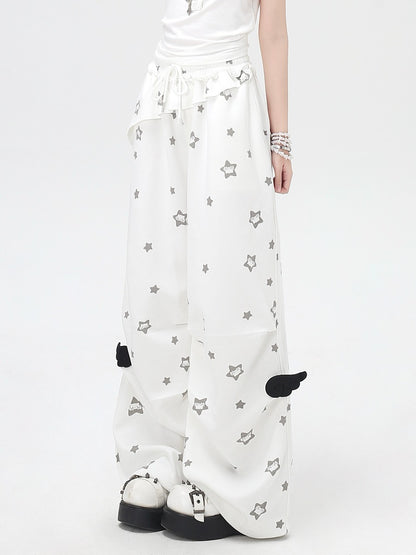 White pants with star pattern worn by a person on a white background