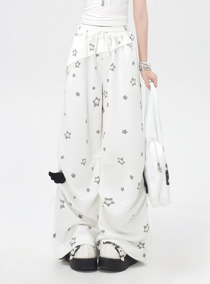 White pants with star patterns and black accents on a white background