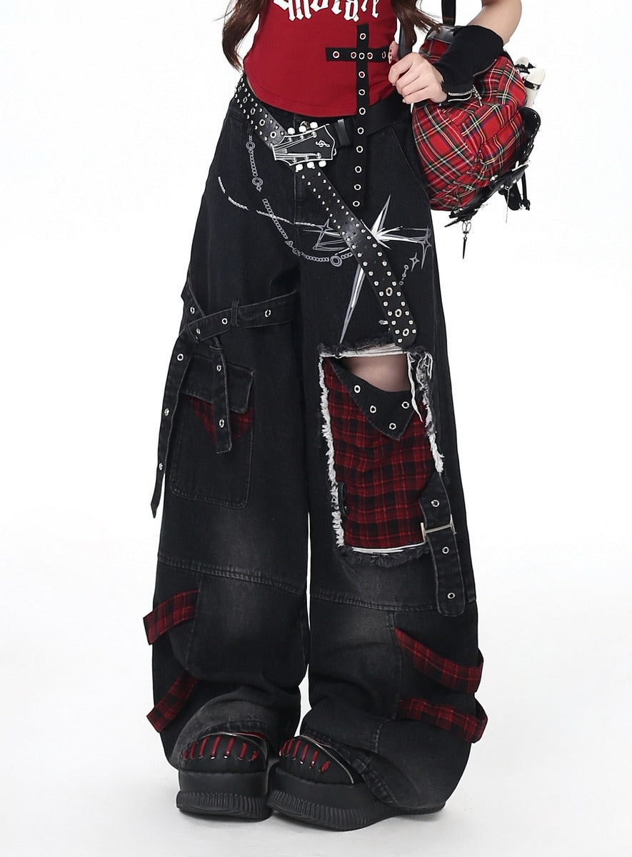 Person wearing black ripped jeans with red accents and plaid patterns on a white background