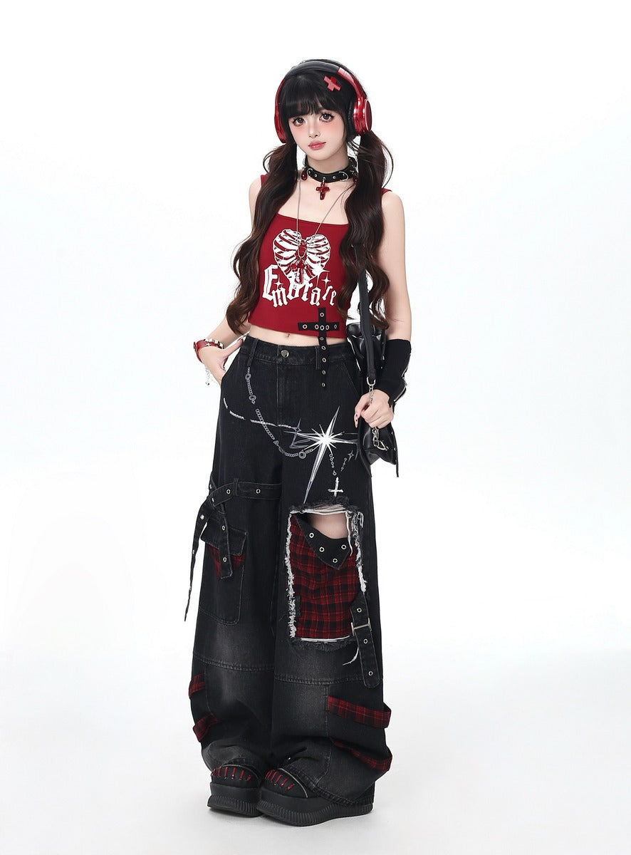 Person wearing a gothic emo outfit with a red top and black jeans on a white background