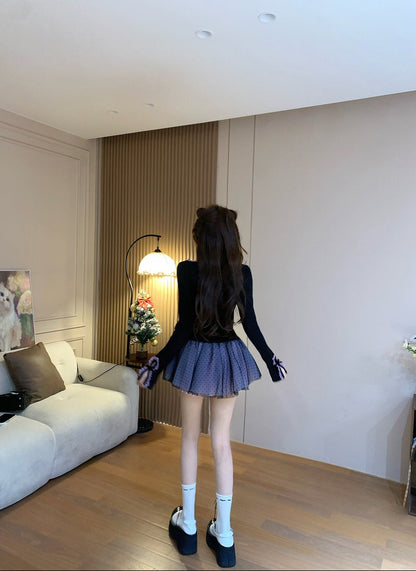 Person standing in a modern living room with a sofa and decorative items.