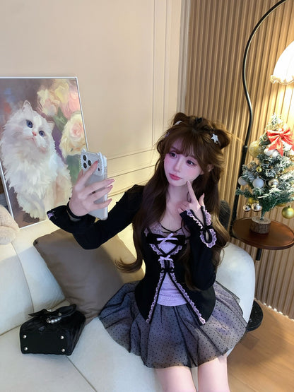 Woman taking a selfie in a room with a painting of a cat and decorative items.