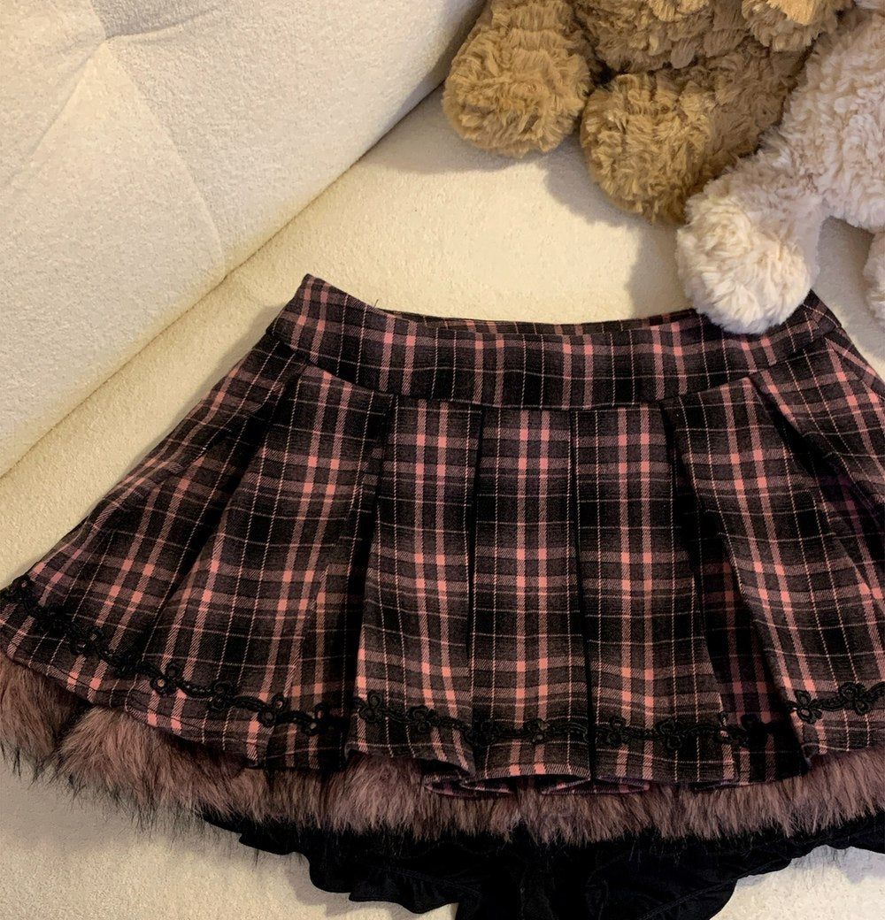Plaid skirt with black trim on a light-colored surface with teddy bears in the background