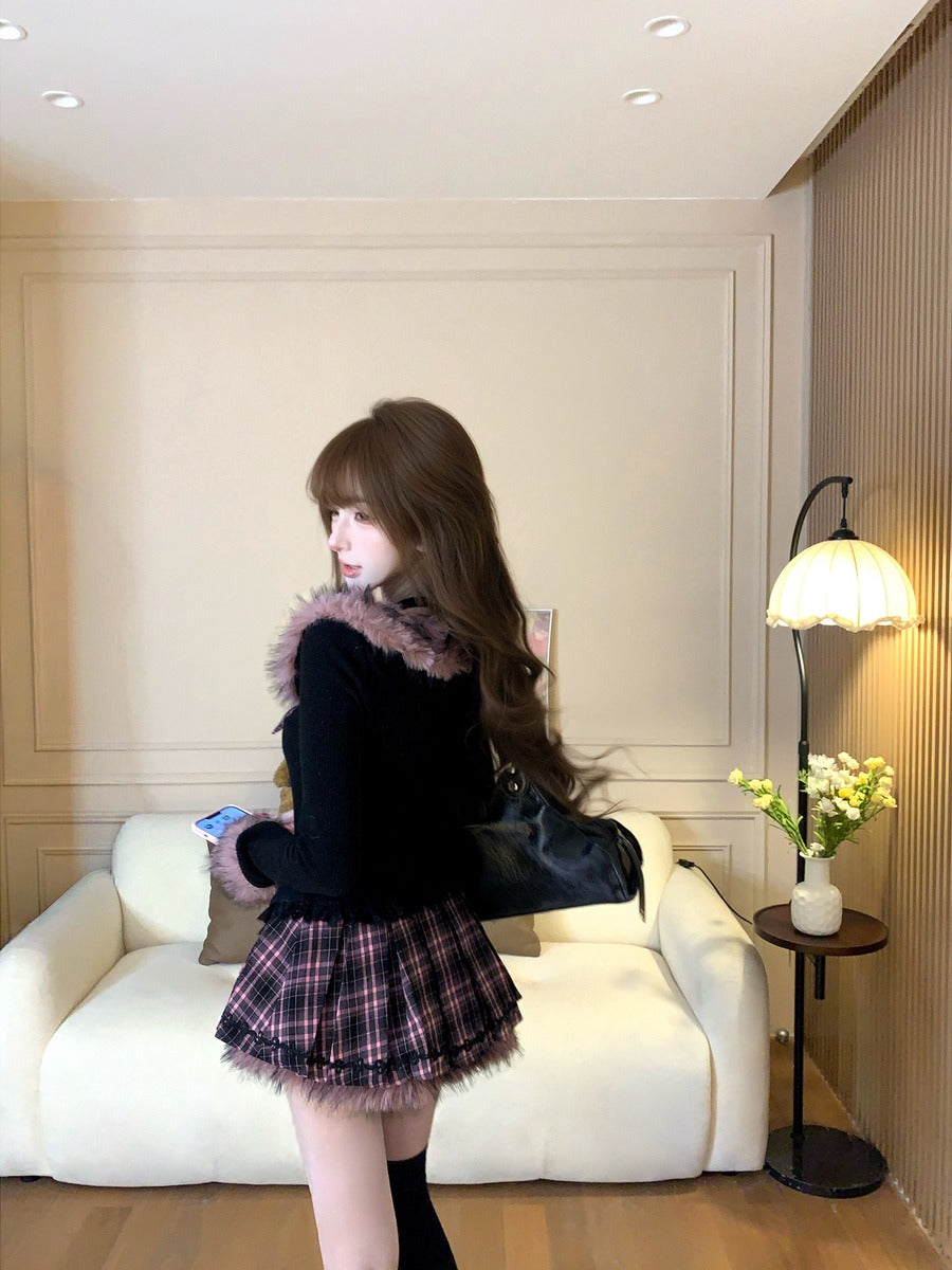 Woman in a stylish outfit standing in a room with a white couch and lamp.