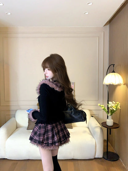 Woman in a stylish outfit standing in a room with a white couch and lamp.