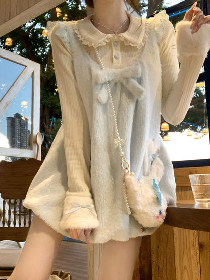 Person wearing a light-colored outfit with a fluffy accessory, sitting at an outdoor cafe.