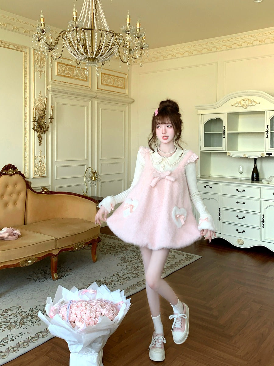 Woman in a pink dress standing in an elegant room with a chandelier and furniture.