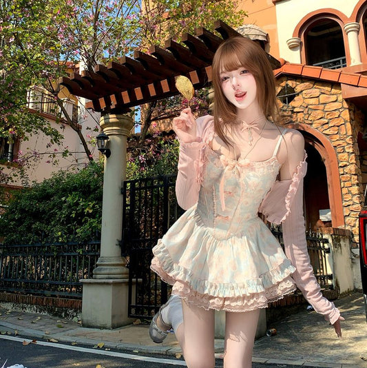 Woman in a light dress standing in front of a building with a decorative archway.