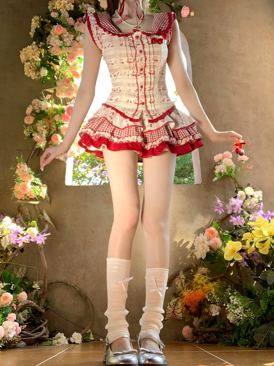 Person wearing a red and white dress with floral decorations in the background